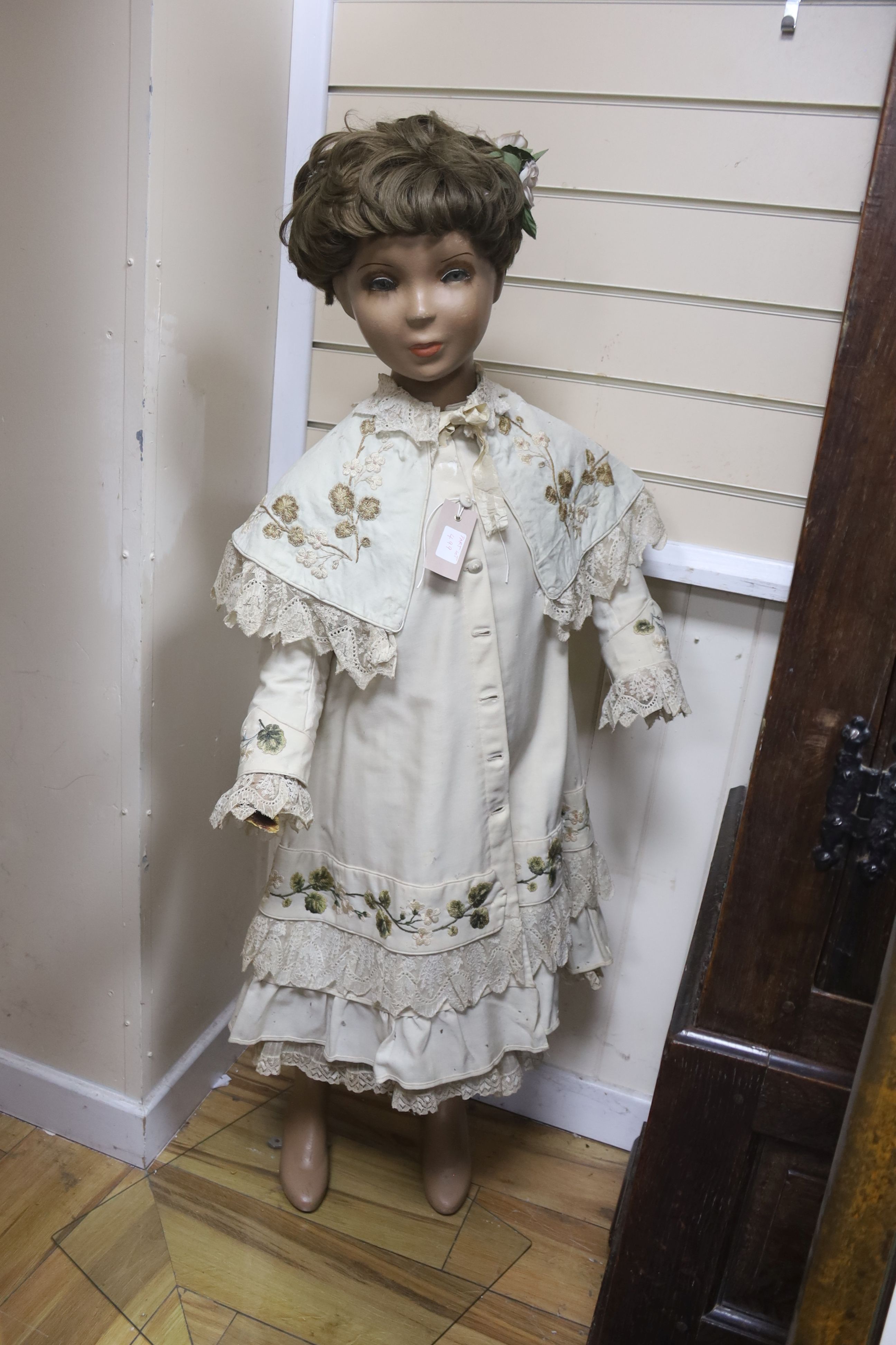 A 1950s full length shop mannequin and a similar together with a Victorian brown silk dress and embroidered coat cape plus clothing,